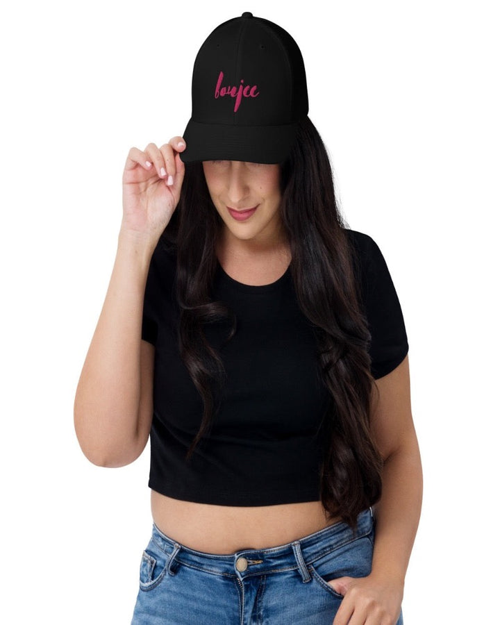 Black trucker hat with boujee in a bold pink text design, complete with a breathable mesh back, and an adjustable snap closure.