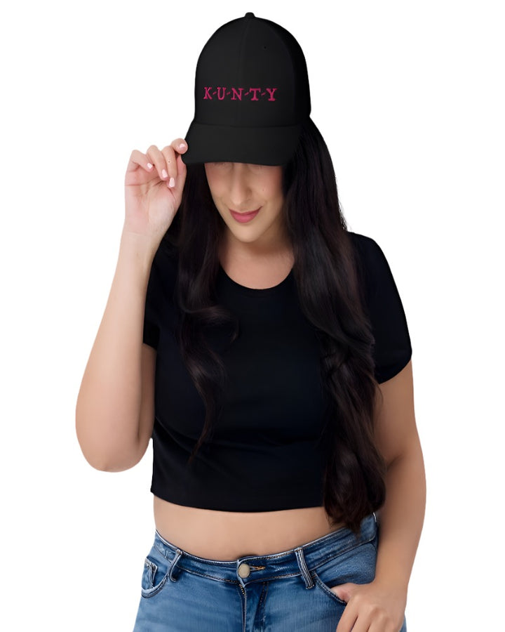 Black trucker hat with K-U-N-T-Y in a bold pink text design, complete with a breathable mesh back, and an adjustable snap closure.