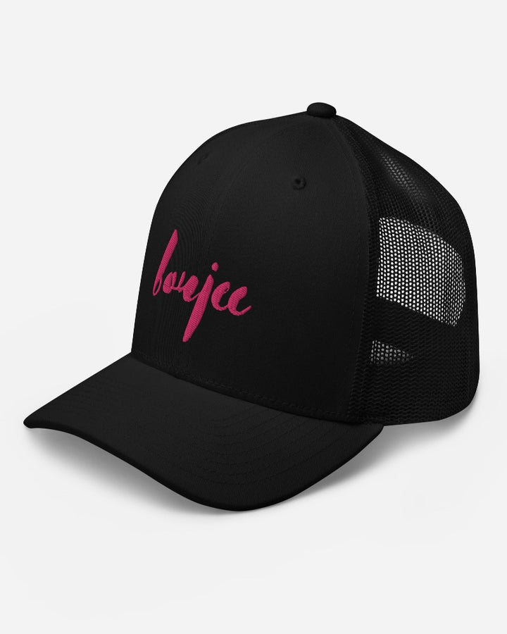 Black trucker hat with boujee in a bold pink text design, complete with a breathable mesh back, and an adjustable snap closure.