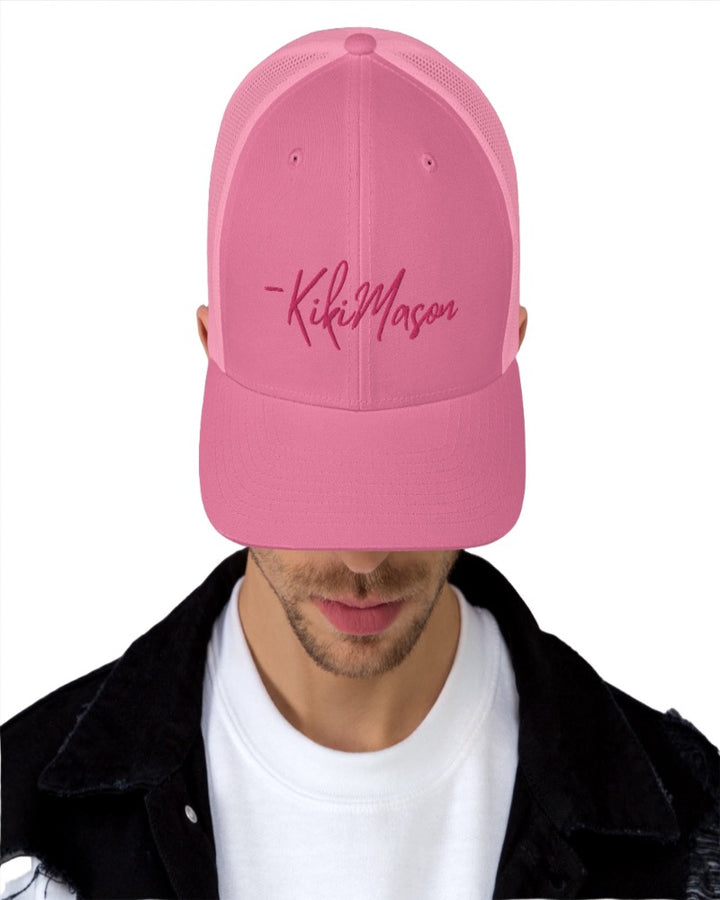 Pink trucker hat with Kiki Mason in a bold pink text design, complete with a breathable mesh back, and an adjustable snap closure.