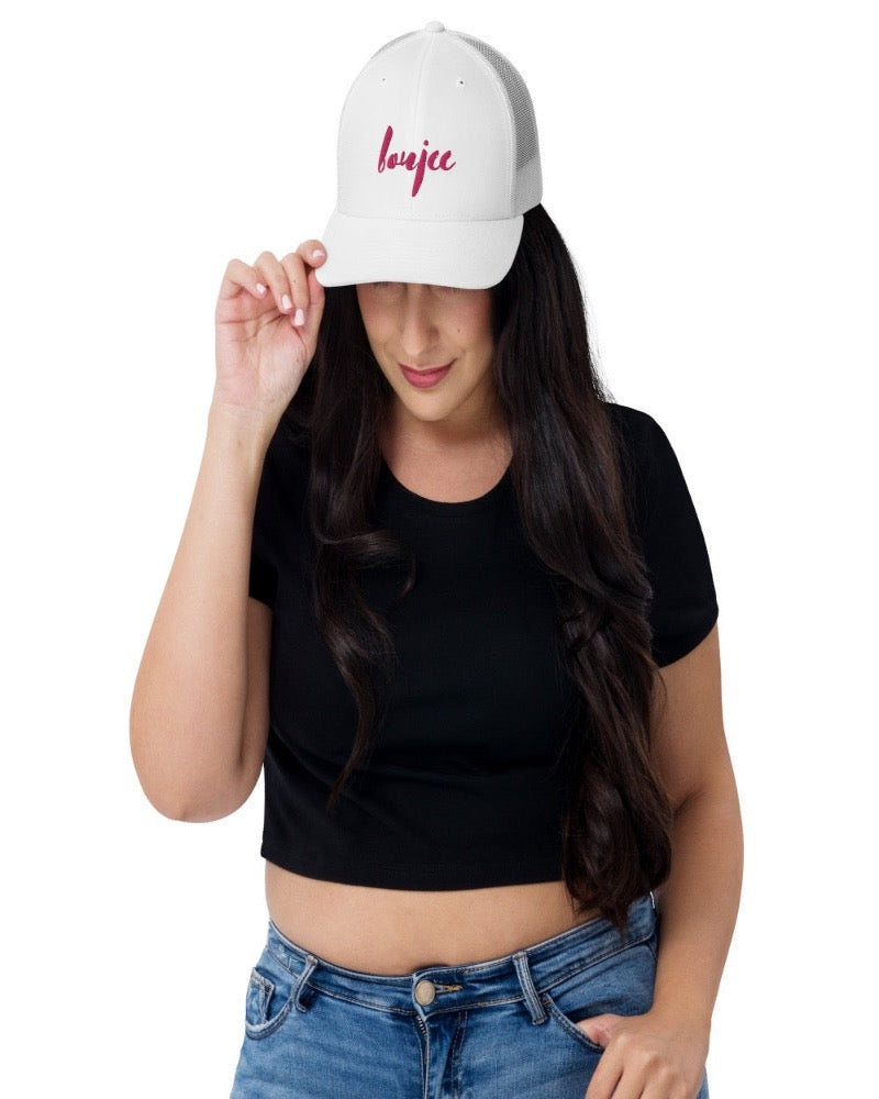 White trucker hat with boujee in a bold pink text design, complete with a breathable mesh back, and an adjustable snap closure.