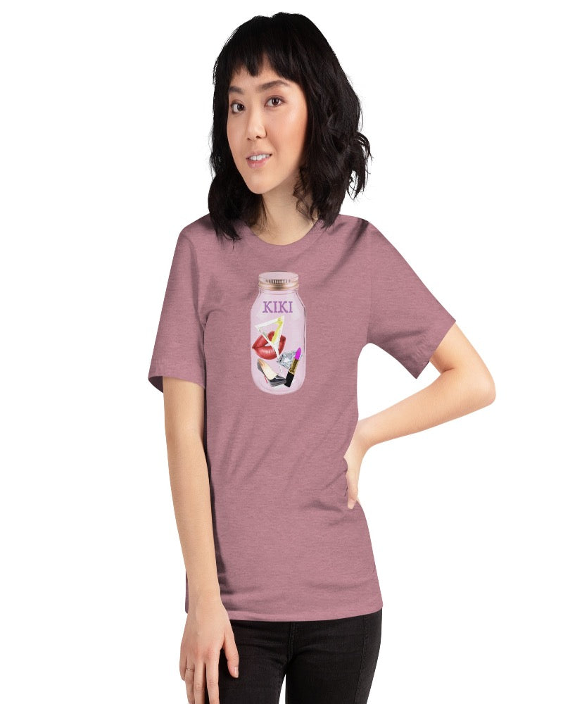 Unisex t-shirt colored heather orchid with KIKI is written on a mason jar below the lid and filled with martini, lipstick, lip, diamond, high heel