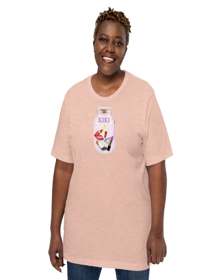 Unisex t-shirt colored heather prism peach with KIKI is written on a mason jar below the lid and filled with martini, lipstick, lip, diamond, high heel