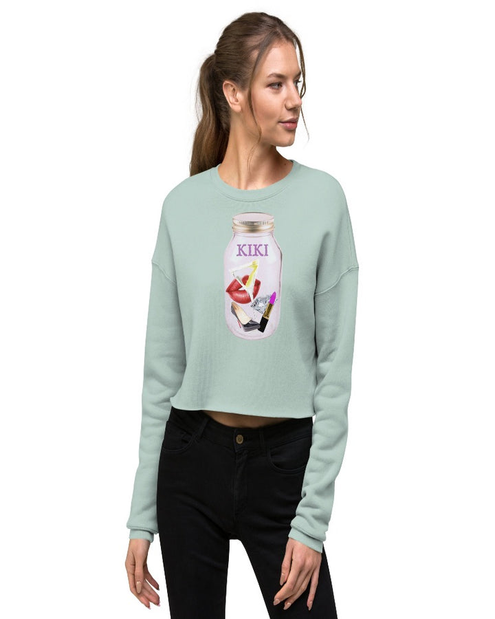 dusty blue colored cropped sweatshirt with KIKI is written on a mason jar below the lid and filled with martini, lipstick, lip, diamond, high heel